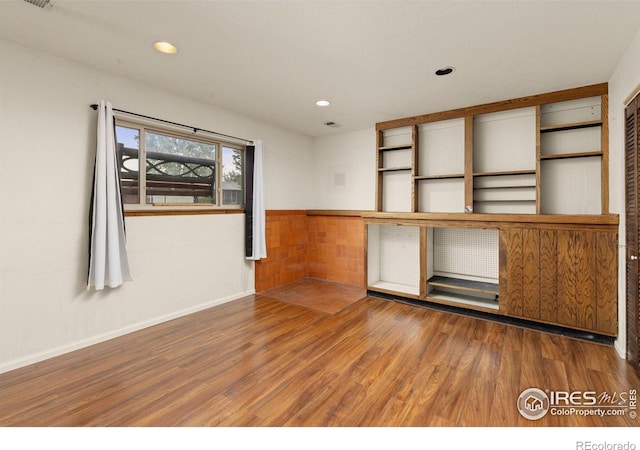 3207 Valmont St, Evans, CO 80620 - spare room featuring wood finished floors and recessed lighting
