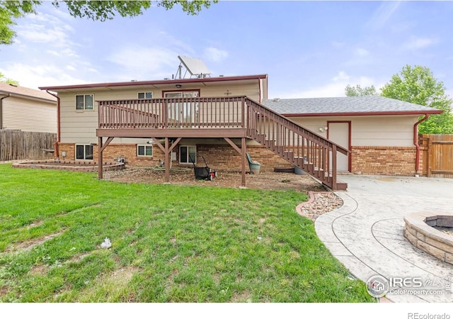 3207 Valmont St, Evans, CO 80620 - back of house with brick siding, stairs, and a wooden deck