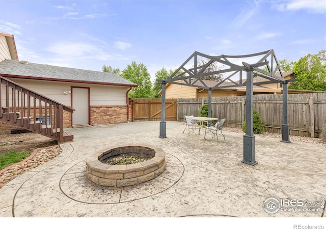 3207 Valmont St, Evans, CO 80620 - fenced backyard with a fire pit, a patio area, and stairs