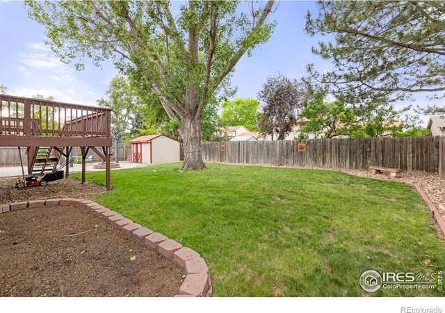 3207 Valmont St, Evans, CO 80620 - fenced backyard with a shed, a wooden deck, and stairway