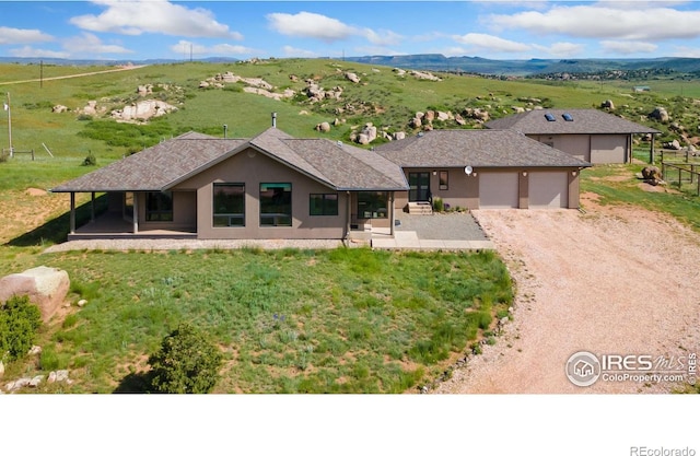 102 Bear Hollow Rd, Laporte, CO 80535 - view of front of house featuring driveway, an attached garage, and stucco siding