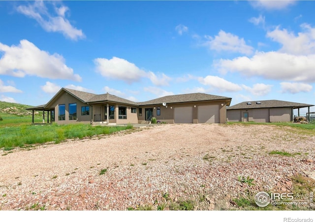 102 Bear Hollow Rd, Laporte, CO 80535 - ranch-style house featuring an attached garage, driveway, and stucco siding