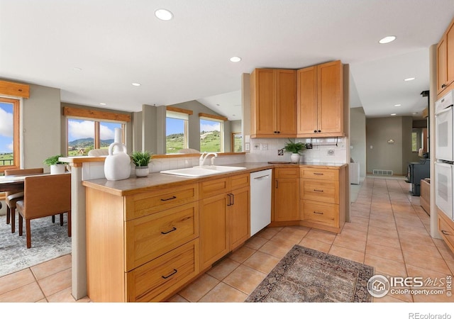 102 Bear Hollow Rd, Laporte, CO 80535 - kitchen featuring white appliances, a peninsula, tasteful backsplash, recessed lighting, and light tile patterned flooring