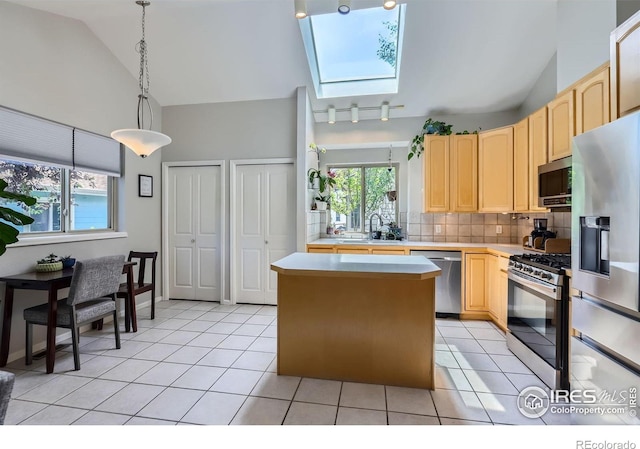 7196 Christopher Ct, Niwot, CO 80503 - kitchen featuring stainless steel appliances, light brown cabinetry, a skylight, light countertops, and backsplash