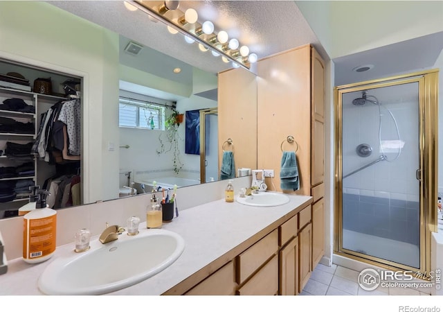7196 Christopher Ct, Niwot, CO 80503 - bathroom with double vanity, a stall shower, tile patterned floors, and a bath