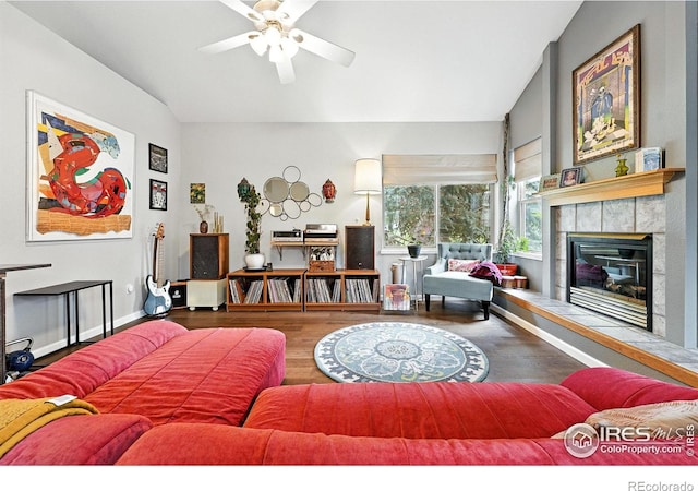 7196 Christopher Ct, Niwot, CO 80503 - living room with lofted ceiling, wood finished floors, ceiling fan, and a tile fireplace