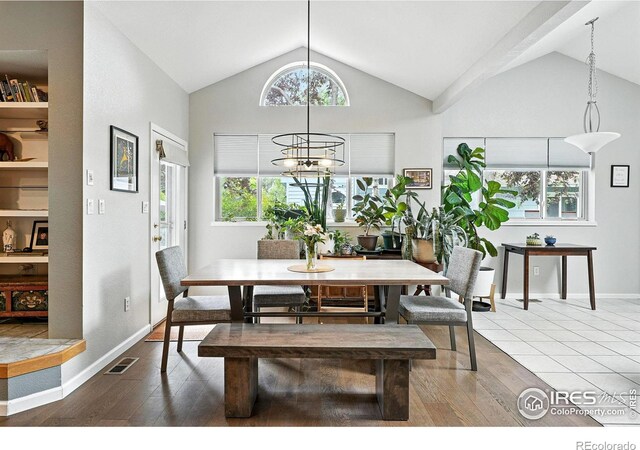 7196 Christopher Ct, Niwot, CO 80503 - dining space with wood finished floors, high vaulted ceiling, and a chandelier