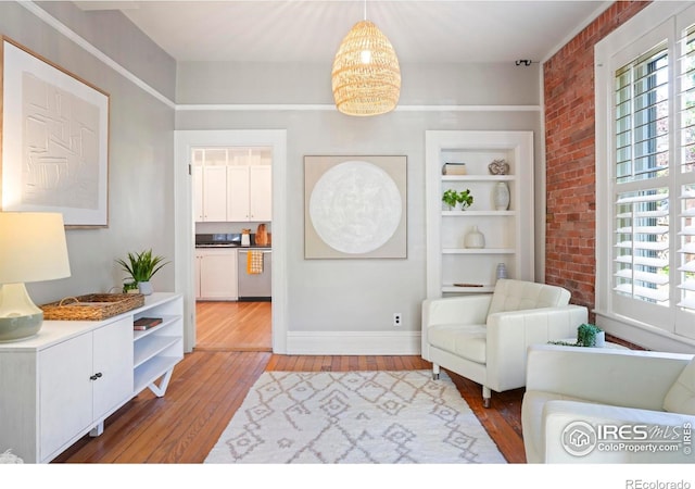 2025 18th St, Boulder, CO 80302 - sitting room with hardwood / wood-style floors, brick wall, and a chandelier