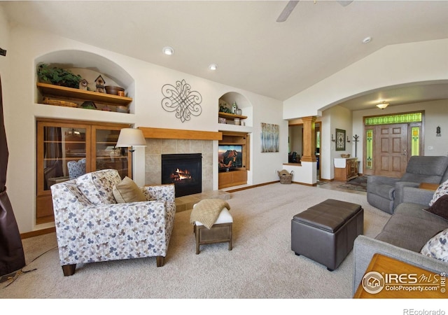 2156 Meander Rd, Windsor, CO 80550 - carpeted living area with decorative columns, vaulted ceiling, built in shelves, arched walkways, and a ceiling fan