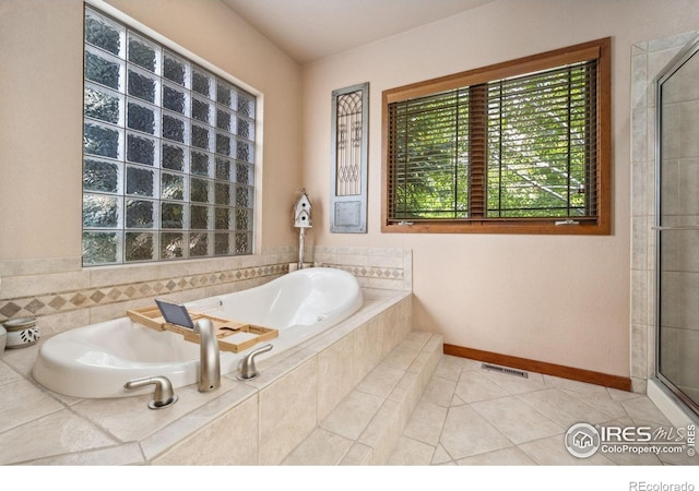 2156 Meander Rd, Windsor, CO 80550 - full bathroom with healthy amount of natural light, a bath, tile patterned floors, and tiled shower