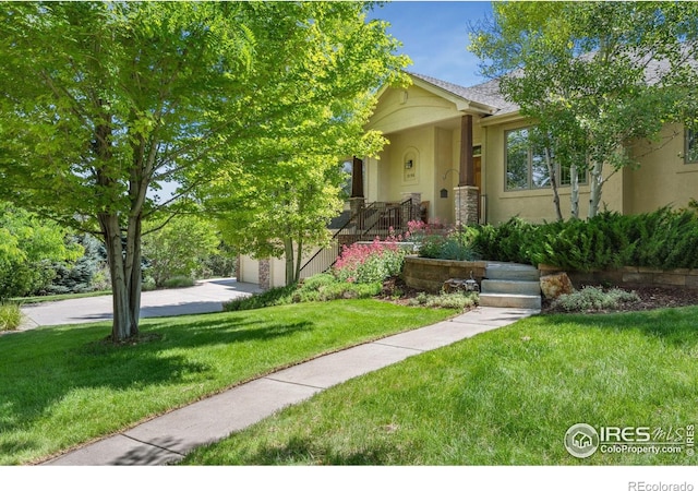 2156 Meander Rd, Windsor, CO 80550 - obstructed view of property featuring stucco siding, a front yard, and a garage