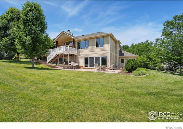 2156 Meander Rd, Windsor, CO 80550 - rear view of house with stairs, a patio area, a wooden deck, a yard, and a chimney