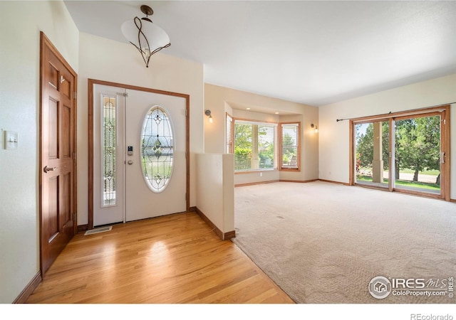 137 Reid Rd, Fort Morgan, CO 80701 - entryway featuring light wood-type flooring and light colored carpet