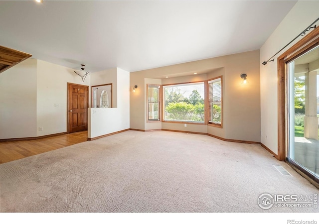 137 Reid Rd, Fort Morgan, CO 80701 - carpeted empty room featuring plenty of natural light