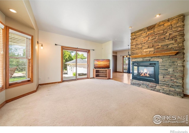 137 Reid Rd, Fort Morgan, CO 80701 - unfurnished living room with carpet and a stone fireplace