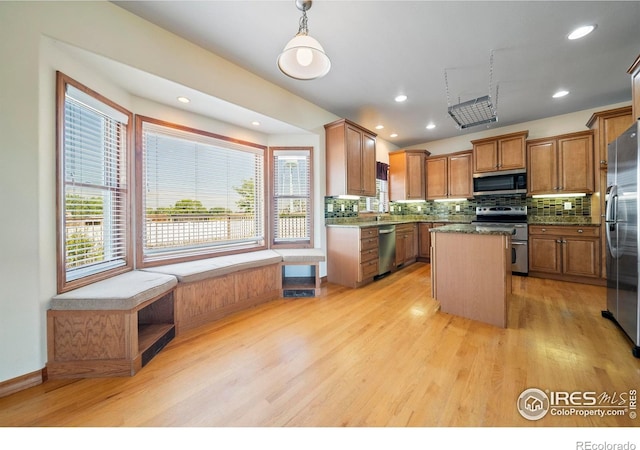137 Reid Rd, Fort Morgan, CO 80701 - kitchen with appliances with stainless steel finishes, backsplash, a center island, plenty of natural light, and recessed lighting