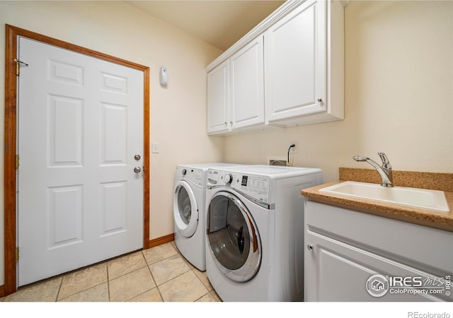 137 Reid Rd, Fort Morgan, CO 80701 - laundry area featuring separate washer and dryer, cabinet space, and light tile patterned floors