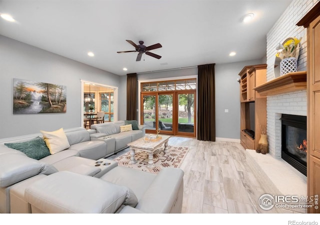 5424 Taylor Ln, Fort Collins, CO 80528 - living room featuring a ceiling fan, recessed lighting, a brick fireplace, and light wood-type flooring