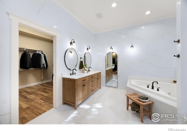 5424 Taylor Ln, Fort Collins, CO 80528 - bathroom with ornamental molding, double vanity, a jetted tub, a walk in closet, and recessed lighting