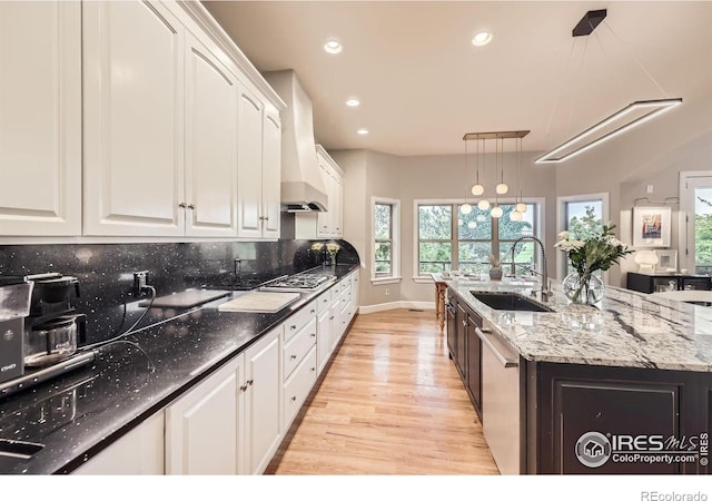 714 Skywalker Pt, Lafayette, CO 80026 - kitchen featuring light wood-style floors, white cabinetry, custom exhaust hood, stainless steel appliances, and recessed lighting