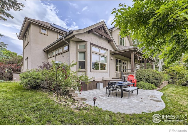 714 Skywalker Pt, Lafayette, CO 80026 - back of property featuring stucco siding, a yard, and a patio area