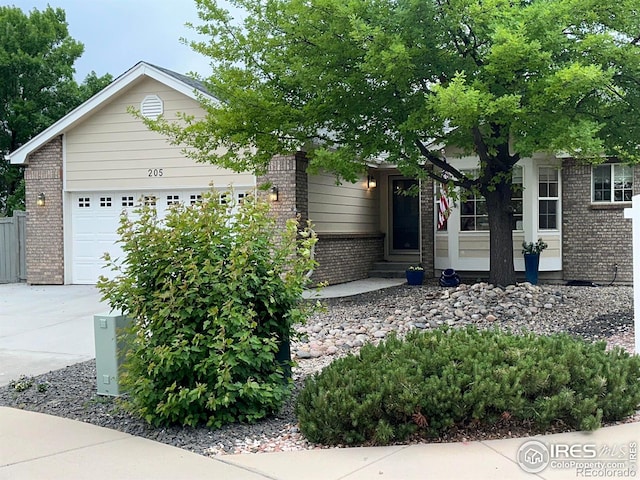 205 Timber Ridge Ct, Severance, CO 80550 - view of front facade with brick siding, driveway, and a garage