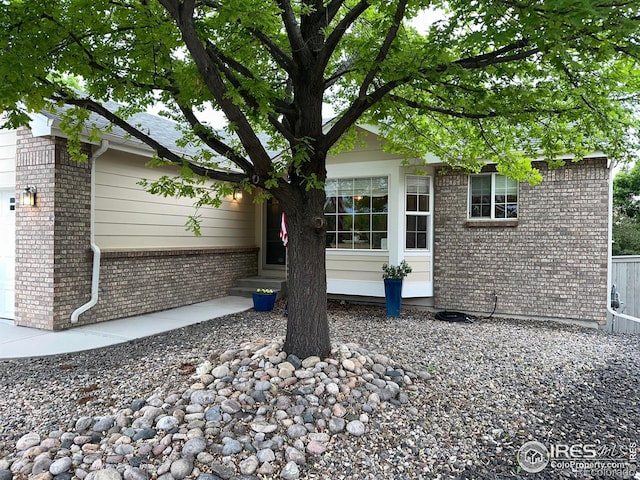 205 Timber Ridge Ct, Severance, CO 80550 - view of property exterior featuring brick siding and a garage