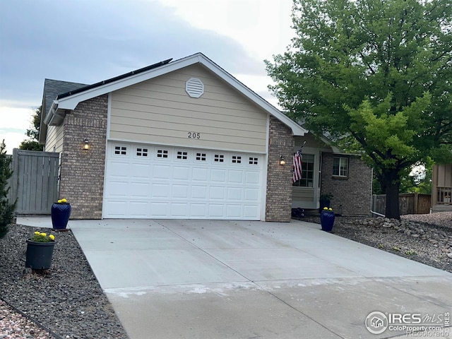 205 Timber Ridge Ct, Severance, CO 80550 - ranch-style house with brick siding, an attached garage, and concrete driveway