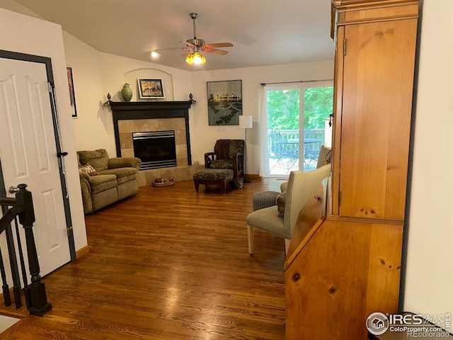 205 Timber Ridge Ct, Severance, CO 80550 - living area with dark wood-style flooring, a ceiling fan, and a tiled fireplace