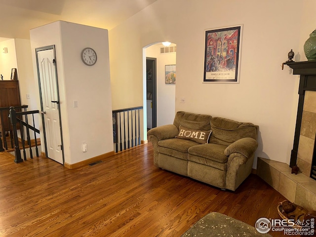 205 Timber Ridge Ct, Severance, CO 80550 - living room with arched walkways, wood finished floors, and a fireplace
