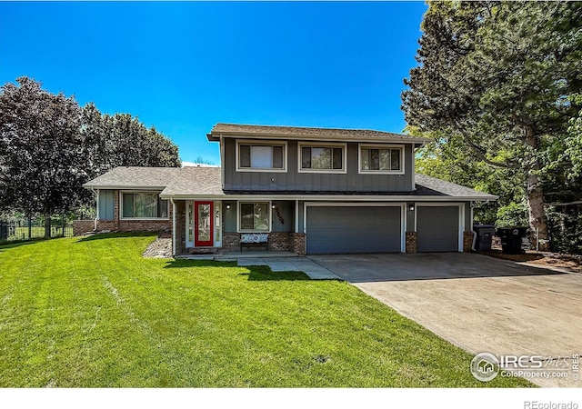 5004 Fox Hill Dr, Longmont, CO 80504 - view of front of property with driveway, a front yard, a garage, brick siding, and board and batten siding