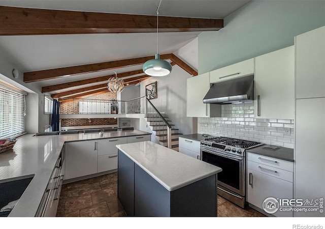 5004 Fox Hill Dr, Longmont, CO 80504 - kitchen with stainless steel gas range, under cabinet range hood, decorative backsplash, and white cabinetry
