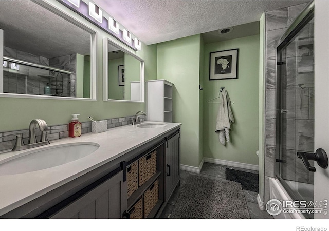 5004 Fox Hill Dr, Longmont, CO 80504 - bathroom featuring a textured ceiling, double vanity, shower / bath combination with glass door, and marble finish floors