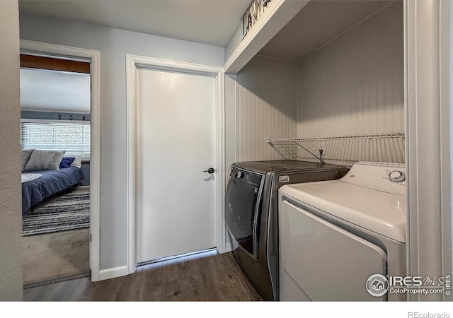 5004 Fox Hill Dr, Longmont, CO 80504 - laundry area with washing machine and clothes dryer and dark wood-type flooring