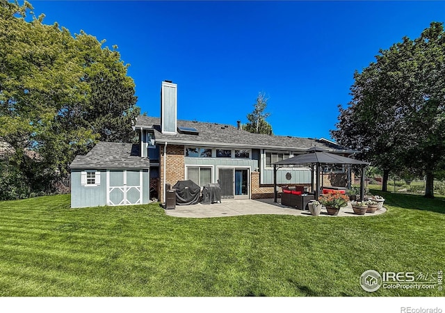 5004 Fox Hill Dr, Longmont, CO 80504 - rear view of house with a patio, a chimney, a gazebo, and a yard