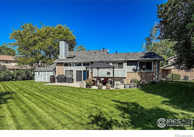 5004 Fox Hill Dr, Longmont, CO 80504 - back of house with a gazebo, a patio area, brick siding, and an outdoor living space