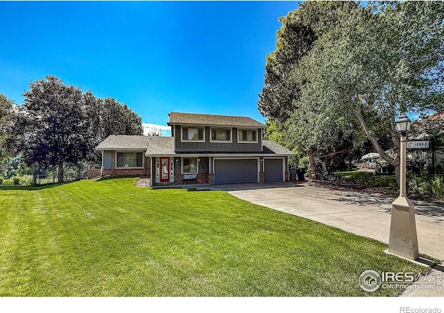 5004 Fox Hill Dr, Longmont, CO 80504 - view of front of property with driveway, an attached garage, a front lawn, and brick siding