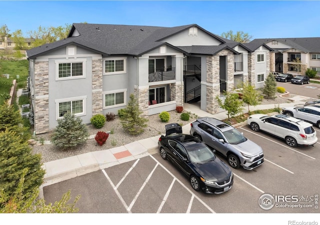 875 E 78th Ave Unit 53, Denver, CO 80229 - view of property featuring uncovered parking
