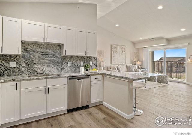 875 E 78th Ave Unit 53, Denver, CO 80229 - kitchen featuring dishwasher, open floor plan, light wood-type flooring, a peninsula, and decorative backsplash