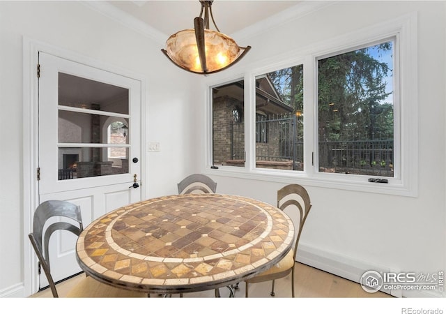 2111 E Alameda Ave, Denver, CO 80209 - dining area featuring light wood finished floors, crown molding, and plenty of natural light