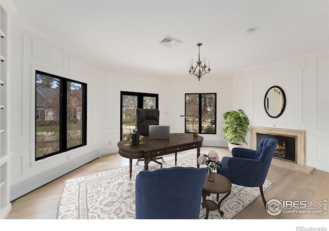 2111 E Alameda Ave, Denver, CO 80209 - office space with a decorative wall, a premium fireplace, ornamental molding, light wood-style flooring, and a chandelier