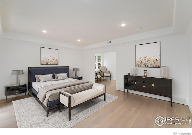 2111 E Alameda Ave, Denver, CO 80209 - bedroom with a raised ceiling, light wood-type flooring, and recessed lighting