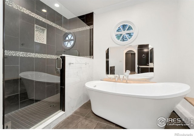 2111 E Alameda Ave, Denver, CO 80209 - bathroom featuring a freestanding tub, a stall shower, and tile patterned floors
