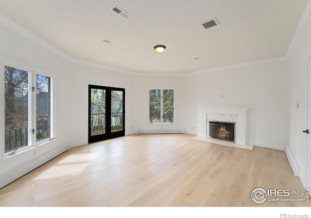 2111 E Alameda Ave, Denver, CO 80209 - unfurnished living room with plenty of natural light, light wood-type flooring, a high end fireplace, and ornamental molding