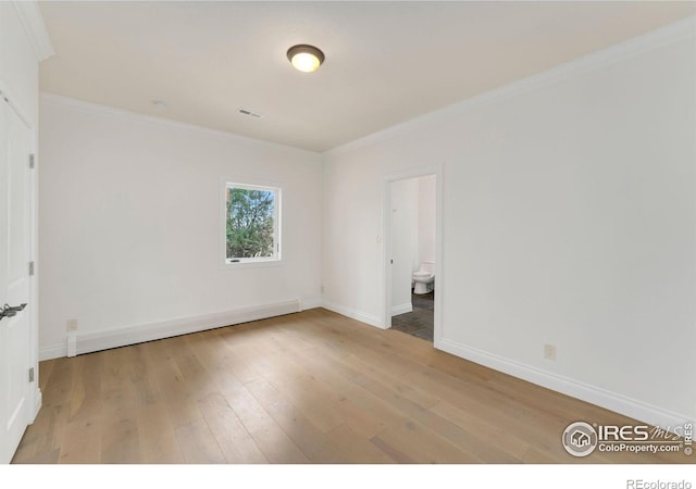 2111 E Alameda Ave, Denver, CO 80209 - spare room featuring wood finished floors and crown molding