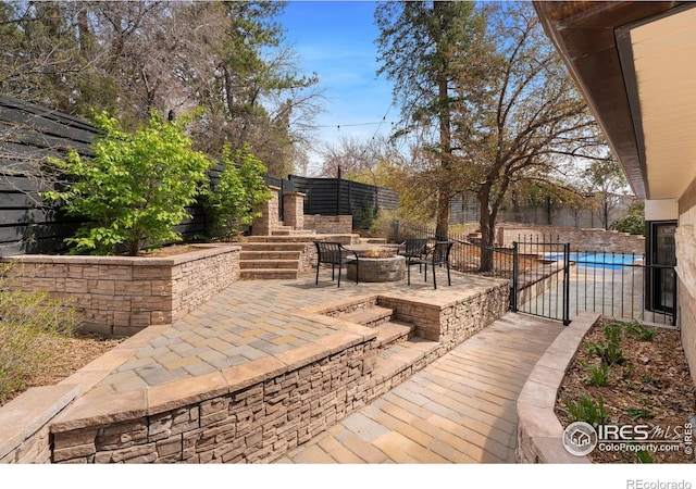 2111 E Alameda Ave, Denver, CO 80209 - view of patio / terrace with a fire pit