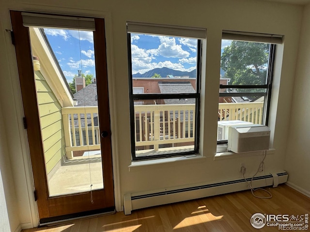 3025 Broadway St Unit 17, Boulder, CO 80304 - doorway to outside featuring a baseboard radiator, wood finished floors, and a mountain view