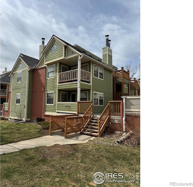 3025 Broadway St Unit 17, Boulder, CO 80304 - rear view of property with a chimney, a balcony, and a yard