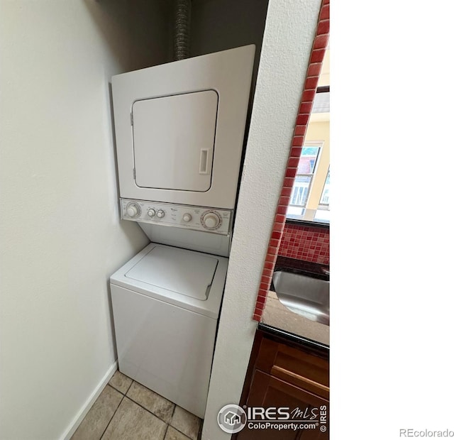 3025 Broadway St Unit 17, Boulder, CO 80304 - laundry area with stacked washer / drying machine and light tile patterned flooring