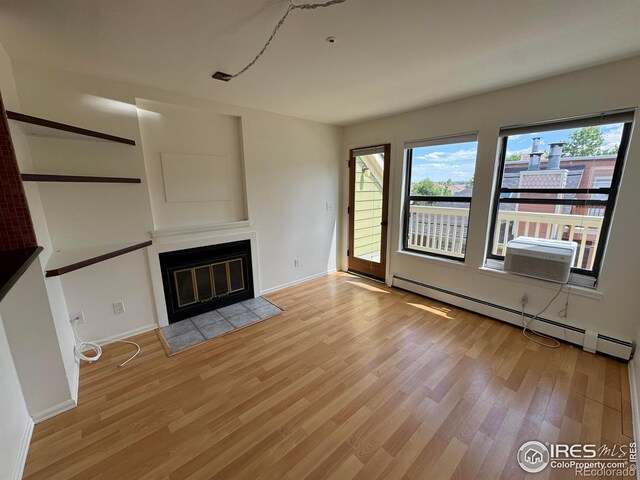 3025 Broadway St Unit 17, Boulder, CO 80304 - unfurnished living room featuring baseboard heating, light wood-type flooring, and a fireplace with flush hearth